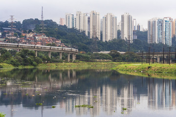 Fototapeta premium Sao Paulo, Brazil, June 01, 2008. Pollution of Pinheiros river by sewage and trash of city in a rain day
