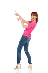 Young Woman Pointing And Sticking Out Tongue