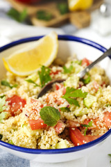 Lemon couscous. Couscous with tomato, cucamber, lemon and herbs. Traditional Arabic Salad Tabbouleh
