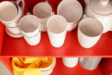 Red storage stand with ceramic dishware