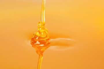 Pouring fresh sweet honey, closeup