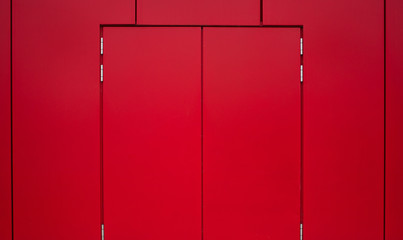 red wall and red door in industrial factory interior background texture concept with empty space for copy or text