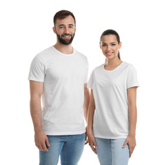 Fototapeta premium Young couple in t-shirts on white background. Mockup for design