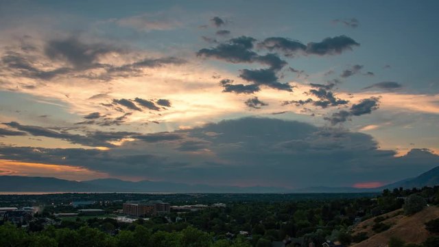 Time lapse of clouds moving across the sky over Provo City and Utah Valley during sunset.
