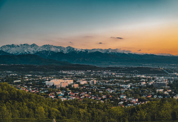 Sunset over the city of Almaty and a view of the Kok Tobe TV Tower
