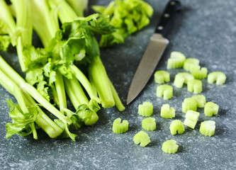 Fresh celery on stone background.