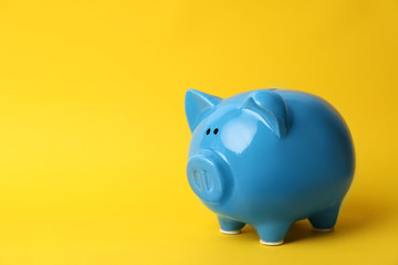 Blue piggy bank on color background. Money saving