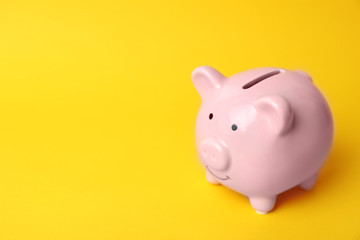 Pink piggy bank on color background. Money saving