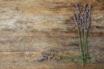 Fototapeta premium Flat lay composition with lavender flowers on wooden background