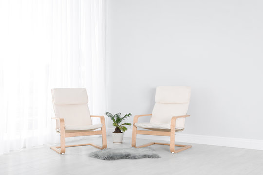 Elegant room interior with stylish comfortable armchairs