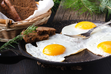 Fried eggs with toasts and drink, traditional breakfast