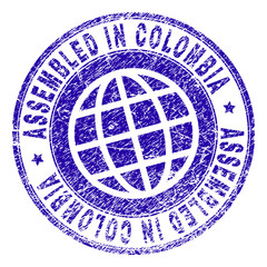 ASSEMBLED IN COLOMBIA stamp watermark with grunge style. Blue vector rubber print of ASSEMBLED IN COLOMBIA caption with grunge texture. Seal has words arranged by circle and globe symbol.