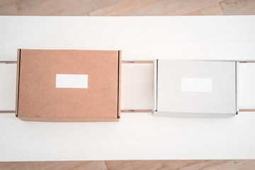 Craft boxes on white table from above. Product packaging, branding mockup, delivery service.