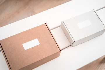 Craft boxes on white table from above. Product packaging, branding mockup, delivery service.