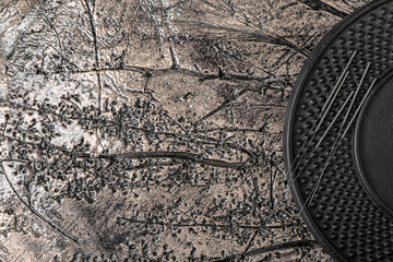 Plate with acupuncture needles on table, top view