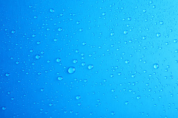 Many clean water drops on color background