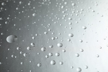 Many clean water drops on grey background