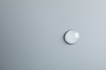 Water drop on light background, top view