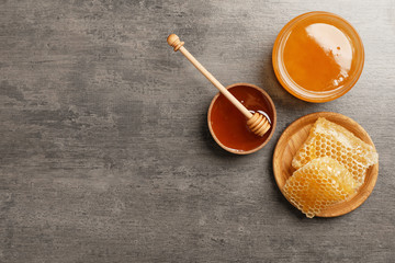 Fototapeta premium Flat lay composition with fresh honey on grey background
