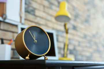 Alarm clock near laptop on table indoors. Time management