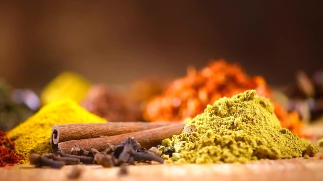 Spice. Various Indian spices and herbs rotated on wooden table. 4K UHD video 3840x2160