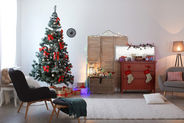 Stylish living room interior with decorated Christmas tree