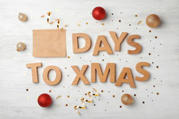 Flat lay composition with words DAYS TO XMAS and holiday decor on wooden background. Christmas countdown