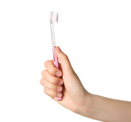 Woman holding manual toothbrush against white background