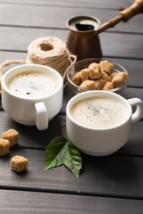 hot black coffee with cookies and beans in cafe