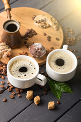 hot black coffee with cookies and beans in cafe