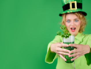 St. Patricks Day. Woman in leprechaun hat. Portrait of smiling girl with green beer. Happy Irish...