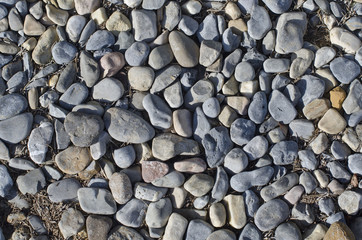 A close up texture of the small pebbles on the path in the walkway. 
