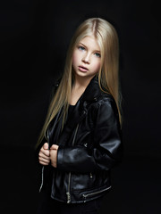 Portrait of the beautiful child on black  background