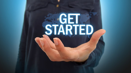 Businesswoman holding get started text over world map