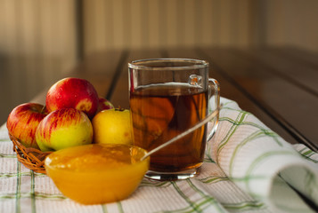 Cup of Tea, Apple, Honey. Tasty and Healthy breakfast on a White Tablecloth. Countryside concept.