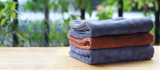 Obraz premium Stack of microfiber cloth on table with copy space.