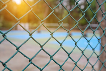 Fototapeta premium Steel wire mesh fence with sunlight.