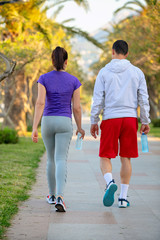 Urban sports, healthy young couple jogging in the city at sunny morning