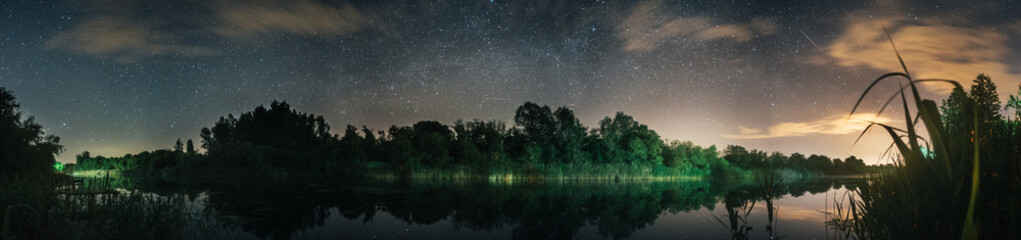 beautiful panoramic view on a sky at the night in a forest and river