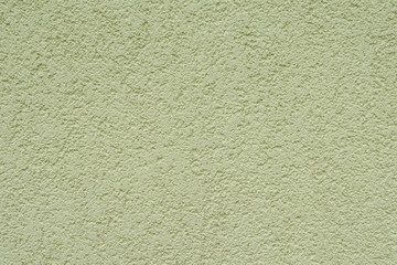 Sample of exterior plaster in lamb style, small granules, close up, olive color, facades of houses, texture and background. Style is popular in Ukraine and Russia