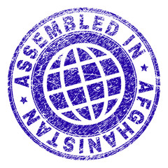 ASSEMBLED IN AFGHANISTAN stamp watermark with grunge texture. Blue vector rubber print of ASSEMBLED IN AFGHANISTAN label with scratched texture. Seal has words placed by circle and planet symbol.