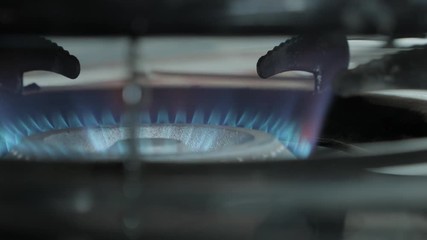 Gas stove is ignited. Flames lit up.