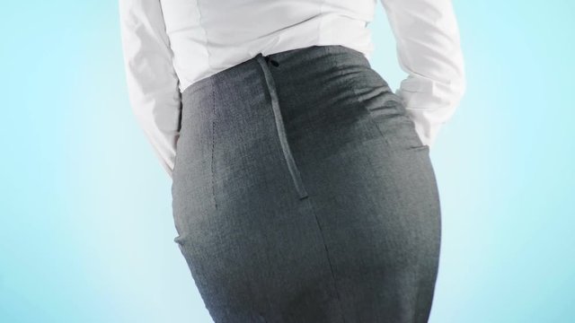 sick business woman with hands holding pressing her crotch lower abdomen. Medical or gynecological problems, healthcare concept. 4k, close-up, color background. Slow motion