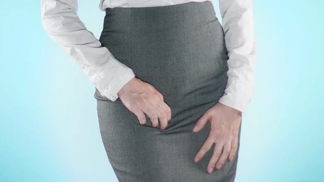 sick business woman with hands holding pressing her crotch lower abdomen. Medical or gynecological problems, healthcare concept. 4k, close-up, color background. Slow motion