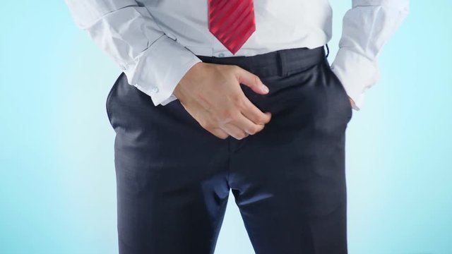a person has problems with the genitourinary system. businessman on a colored background. 4k, close-up, slow-motion shooting.