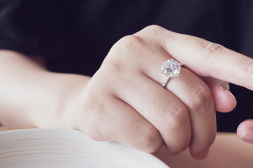 engagement diamond ring on woman finger closeup