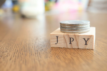 JPY (Japanese Yen) Text Block on Wooden Table