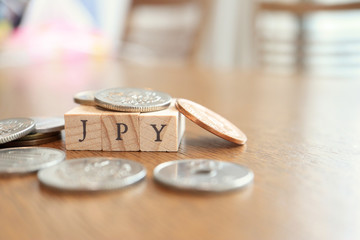 JPY (Japanese Yen) Text Block on Wooden Table