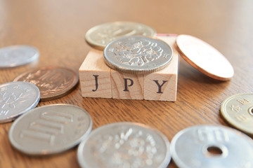 JPY (Japanese Yen) Text Block on Wooden Table