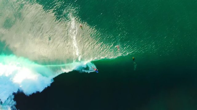 Aerial view of bodysurfer and wave in tropical ocean. Top view